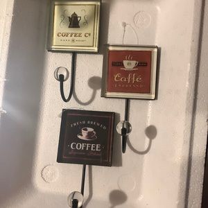 Set of 3 Coffee design hooks made of glass and black metal.